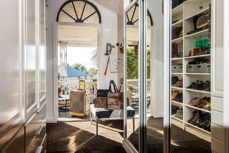 Dressing room with mirrored wardrobes opening onto the front verandah