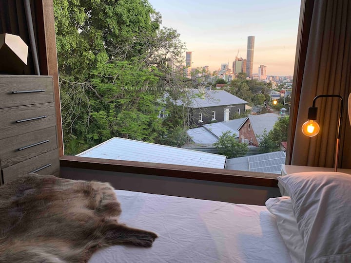 City skyline at dusk seen from the bed through the window