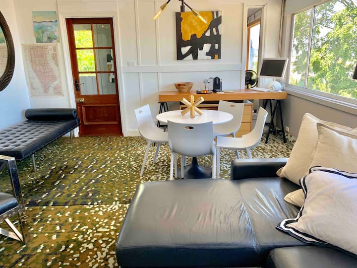 Sitting and dining area with a desk beneath the window