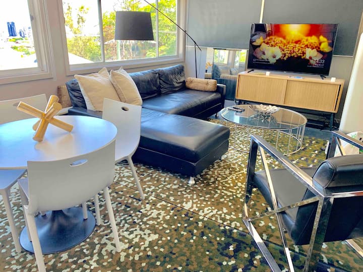 Lounge with a leather sofa, television and city view