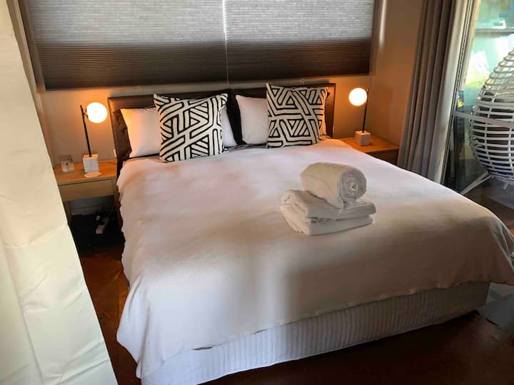 King bed made up with white linen and fresh towels