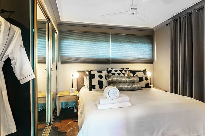 Second bedroom with a ceiling fan, robes and mirrored wardrobe