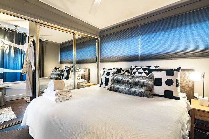 Bedroom with mirrored wardrobes and a mirrored dressing area